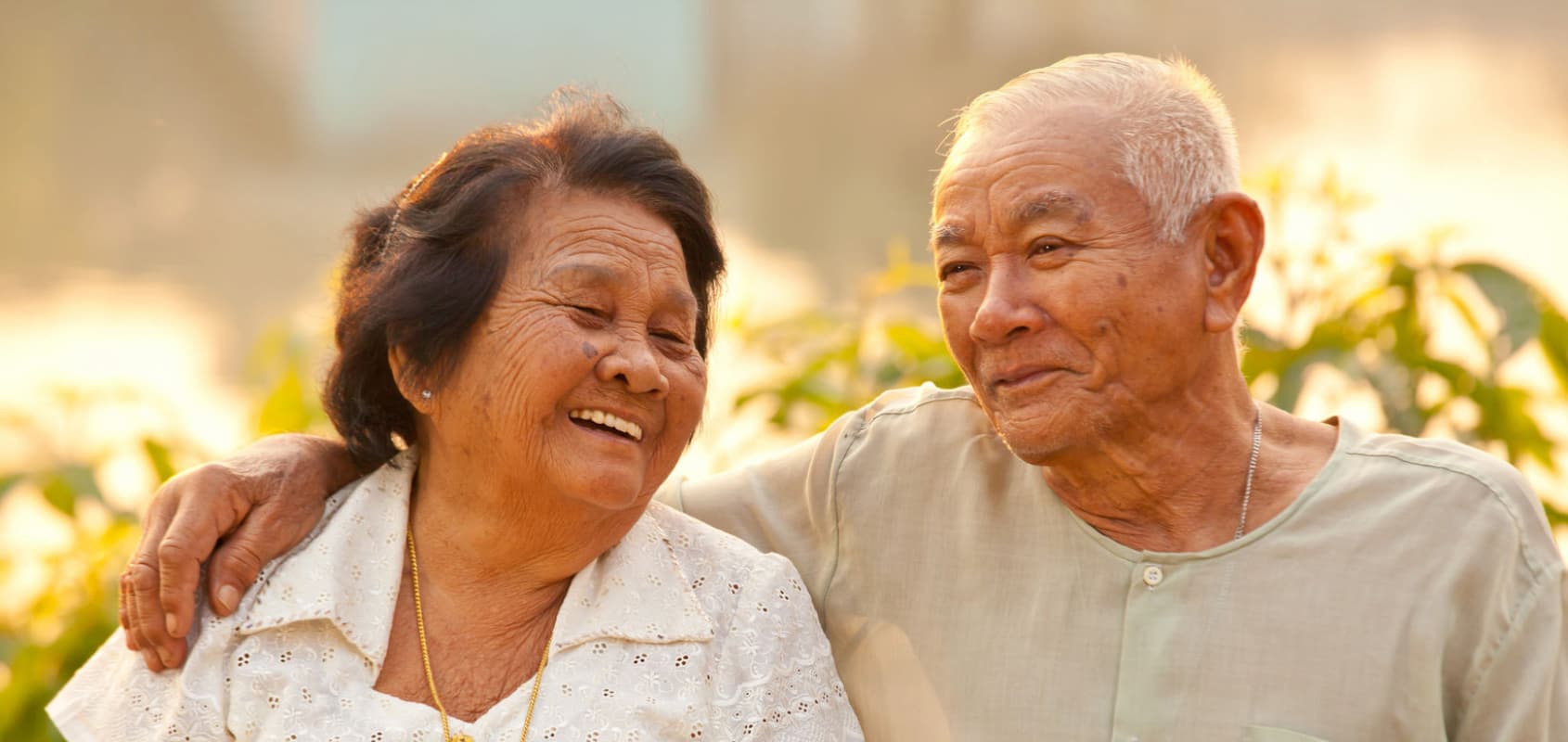 Happy senior asian couple enjoying their golden years, smiling and laughing